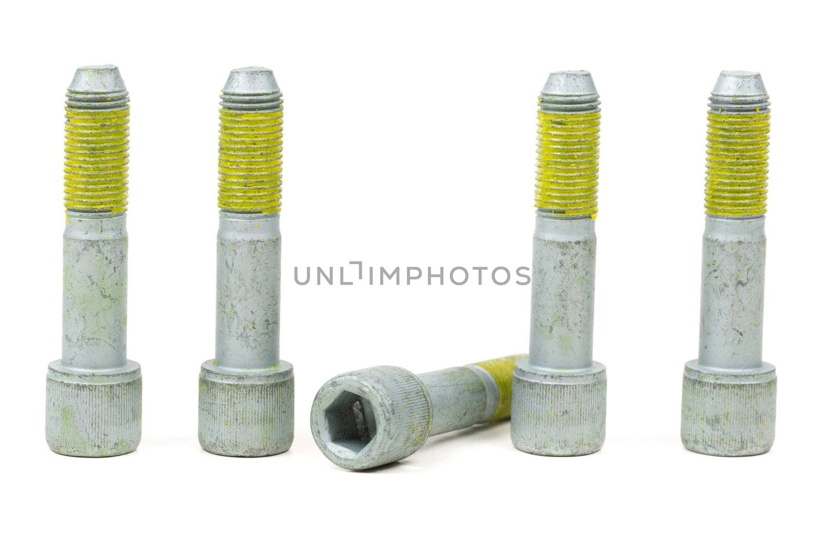 Five bolts for the car with the yellow glue on the threads. Isolate on white