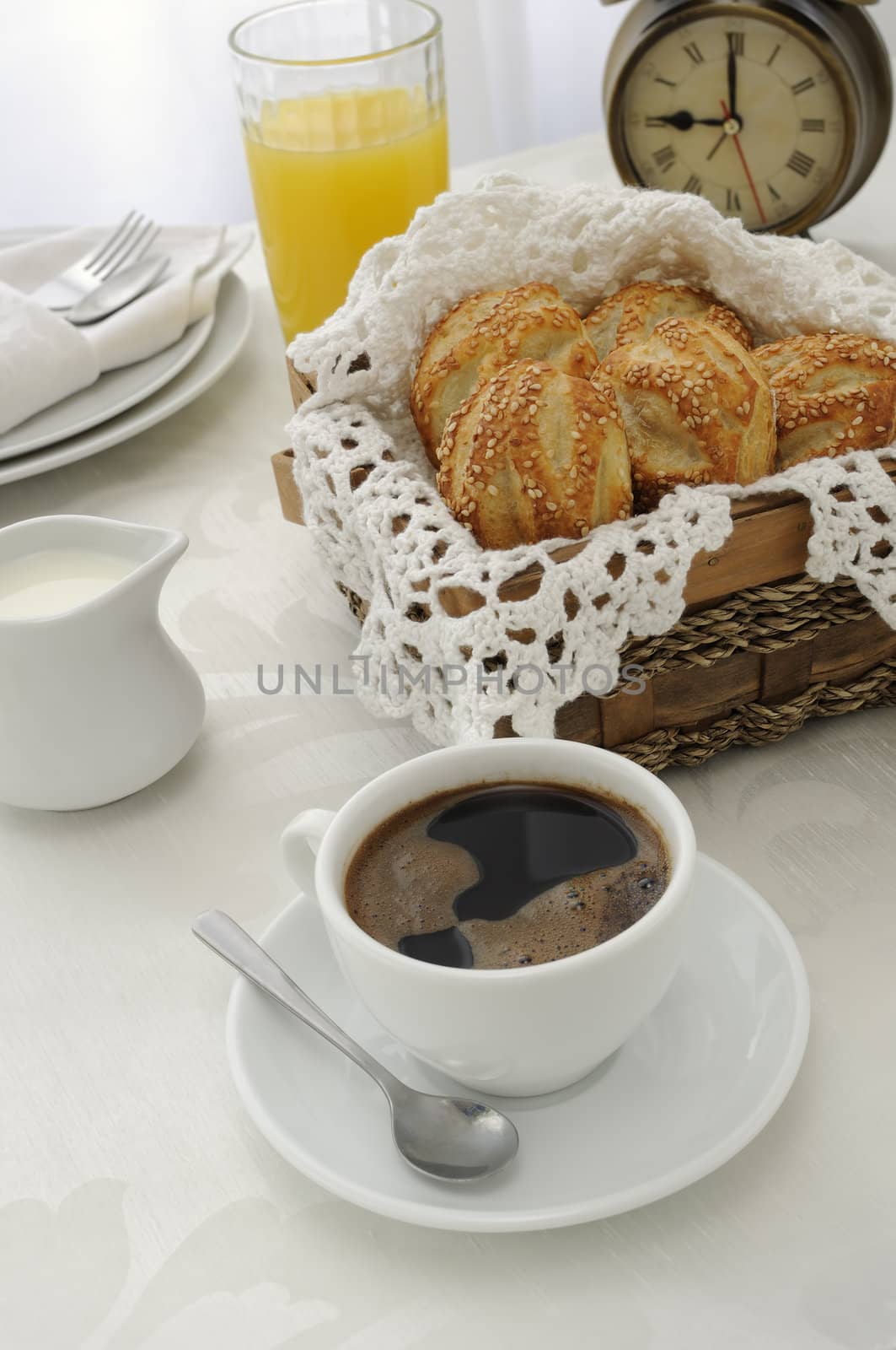  Morning cup of coffee with freshly baked rolls with sesame seeds, juice and milk