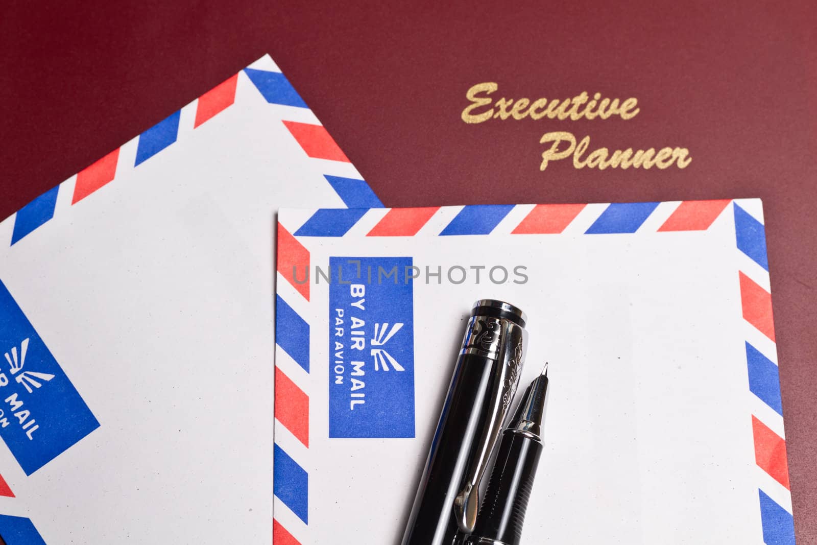 executive planner with two white by air mail envelopes in landscape orientation