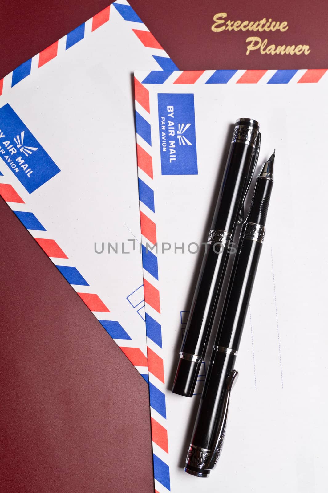 executive planner with two white by air mail envelopes in portrait orientation