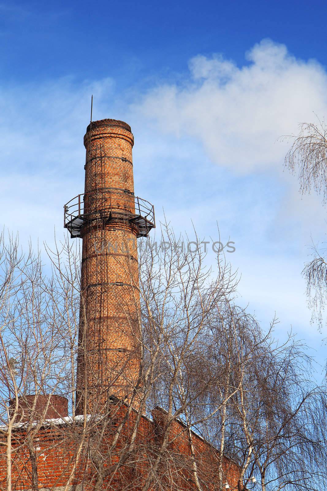 Smoking pipes of thermal power plant against blue sky
