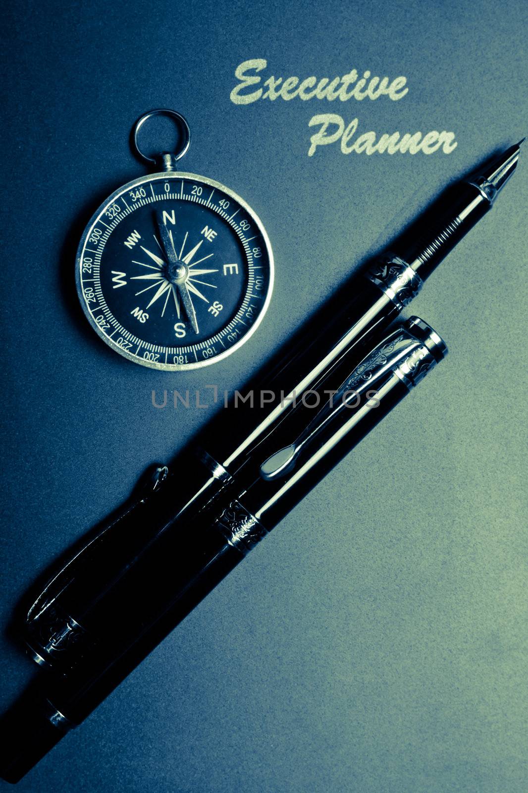 splitted tone of an executive planner with compass and two pens