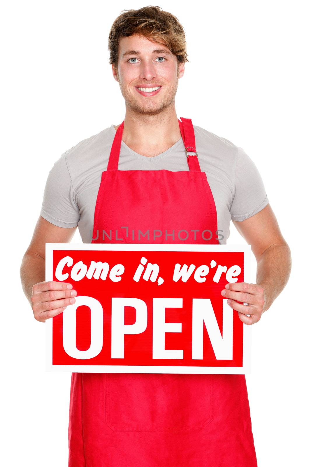 Business owner / employee showing open sign. Man wearing red apron smiling happy. Caucasian male model.