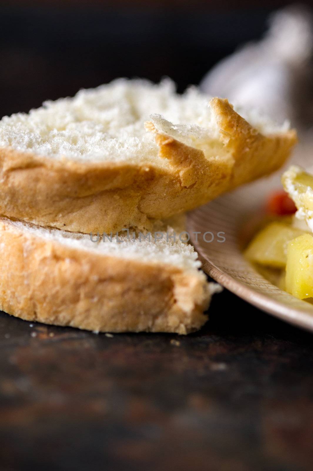 Macro of fresh bread sliced on a dark background