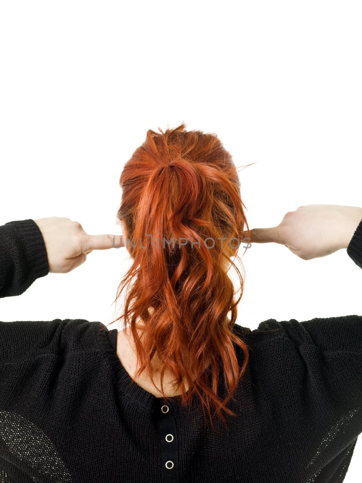 Red haired woman from behind with her fingers in her ears