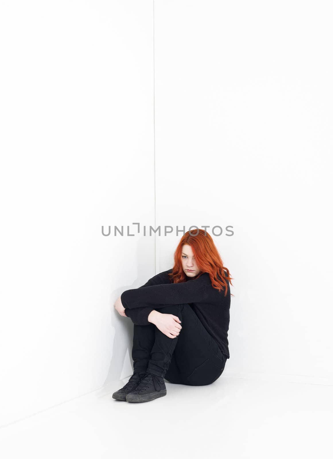 Sad woman in a white room