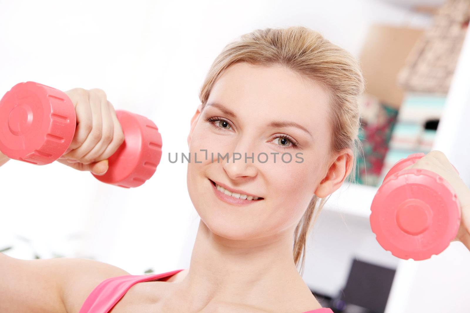 Young beautiful woman with dumbbells by rufatjumali