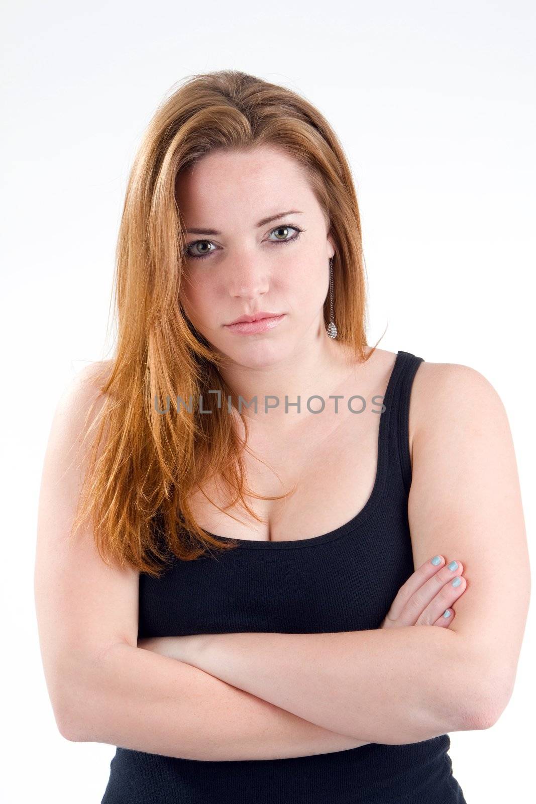 Woman with her arms crossed and a stern unpleasant serious attitude look on her face.