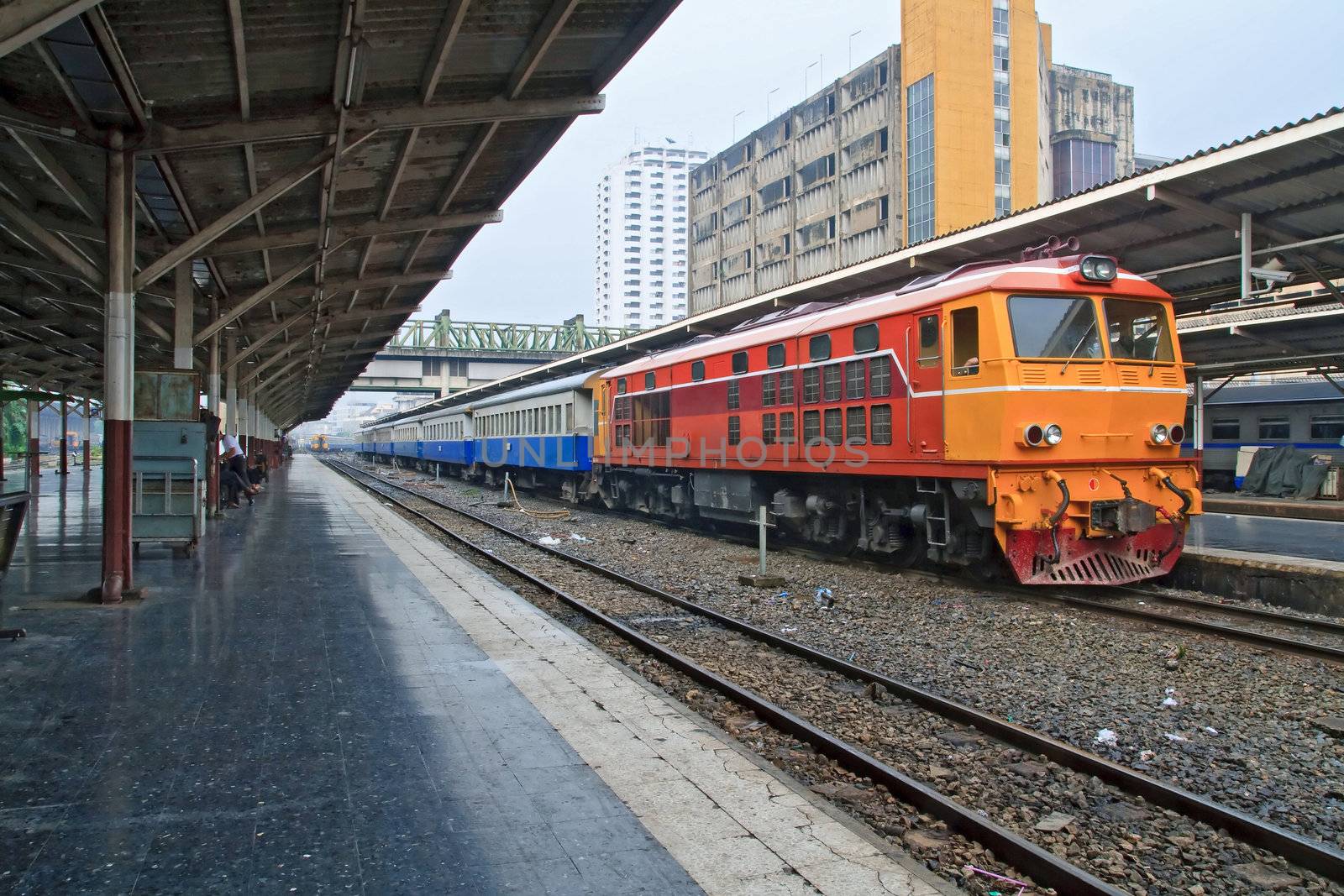 Perspective of Red orange train, Diesel locomotive, on Bangkok railway station platform Thailand