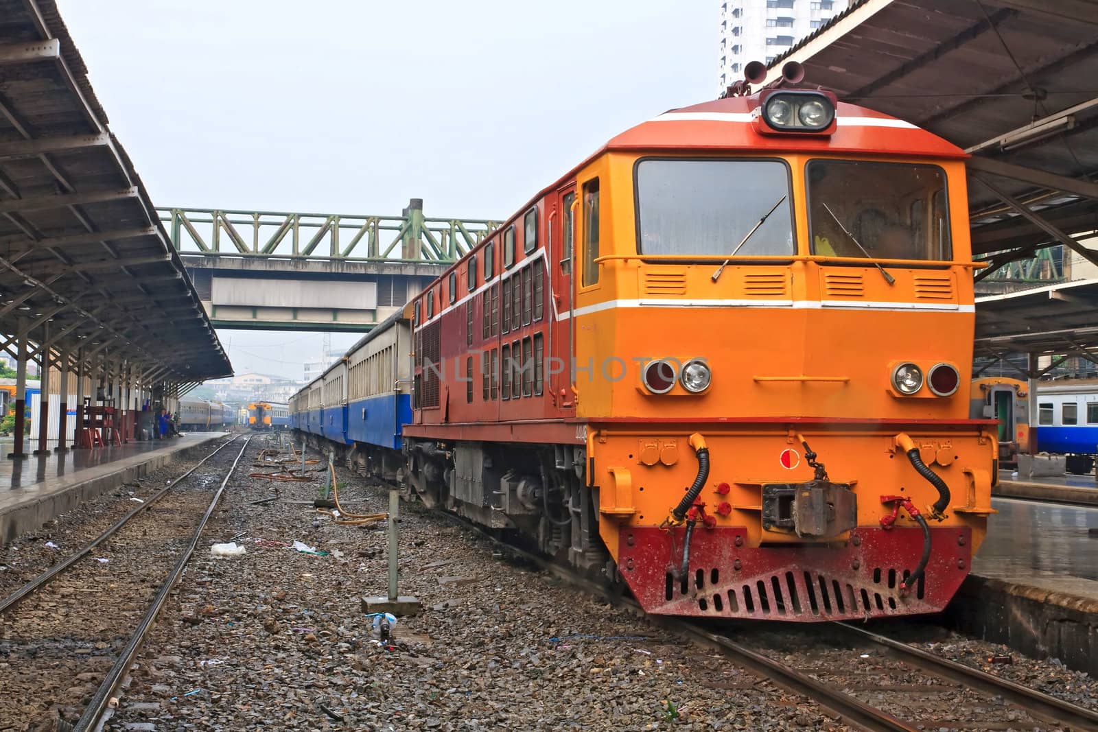 Closeup of Red orange train, Deisel locomotive, on Bangkok railway station platform Thailand