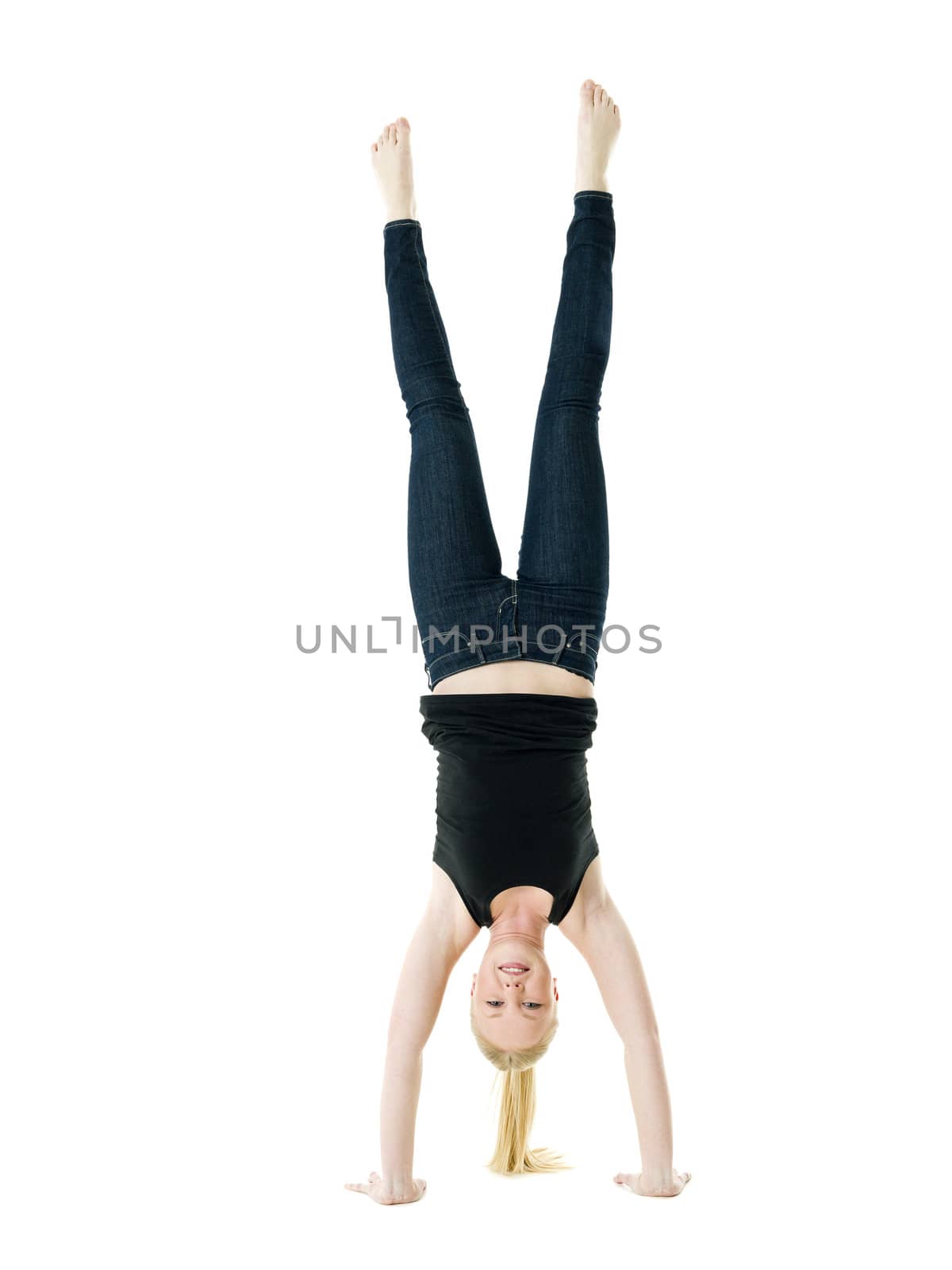 Blond Handstanding woman isolated on white background