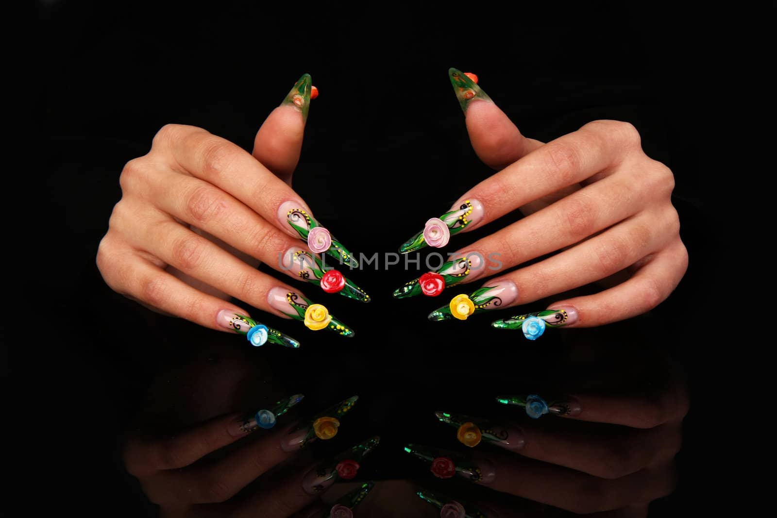 Human fingers with long fingernail and beautiful manicure isolated on black