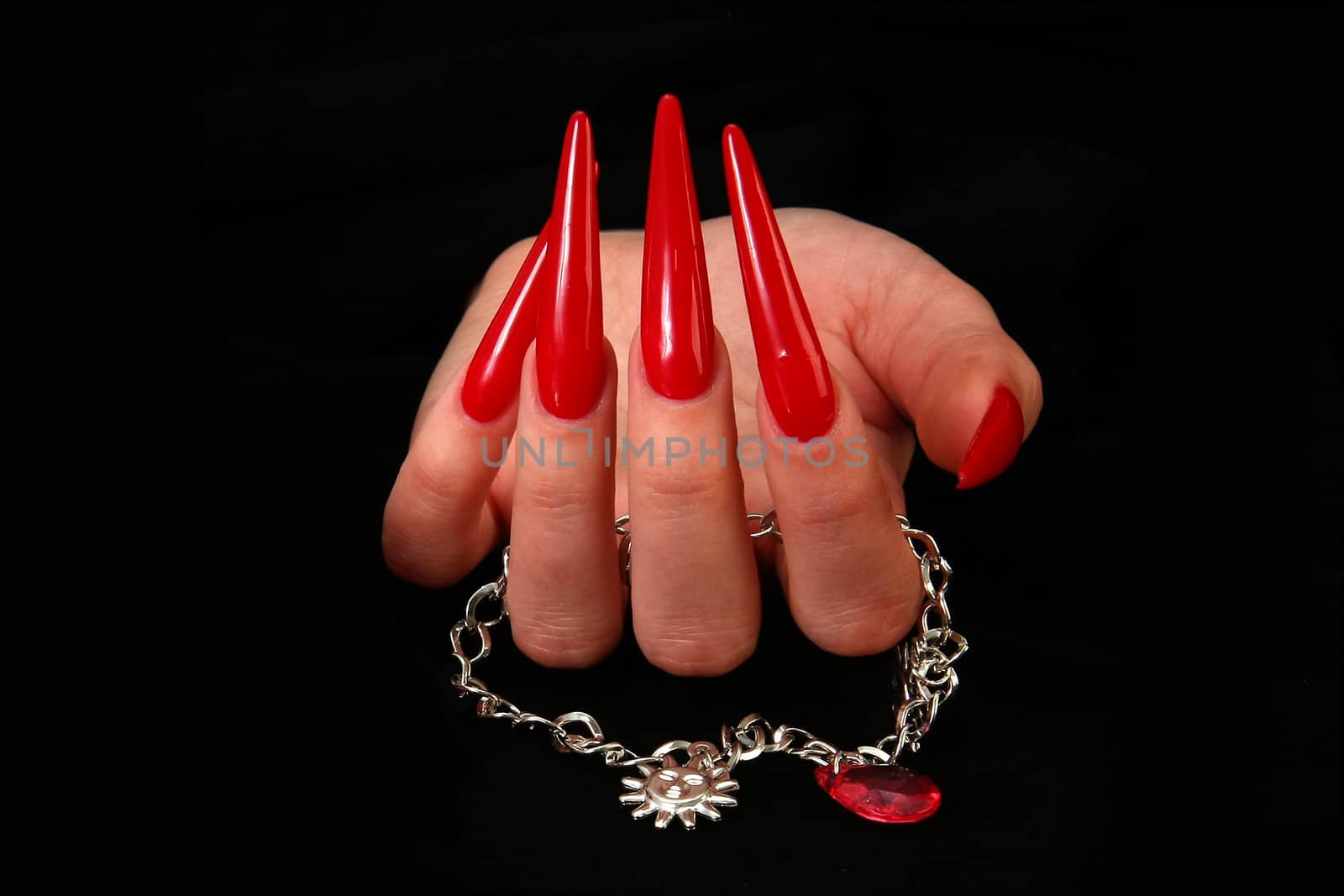 Human fingers with long fingernail and beautiful manicure isolated on black