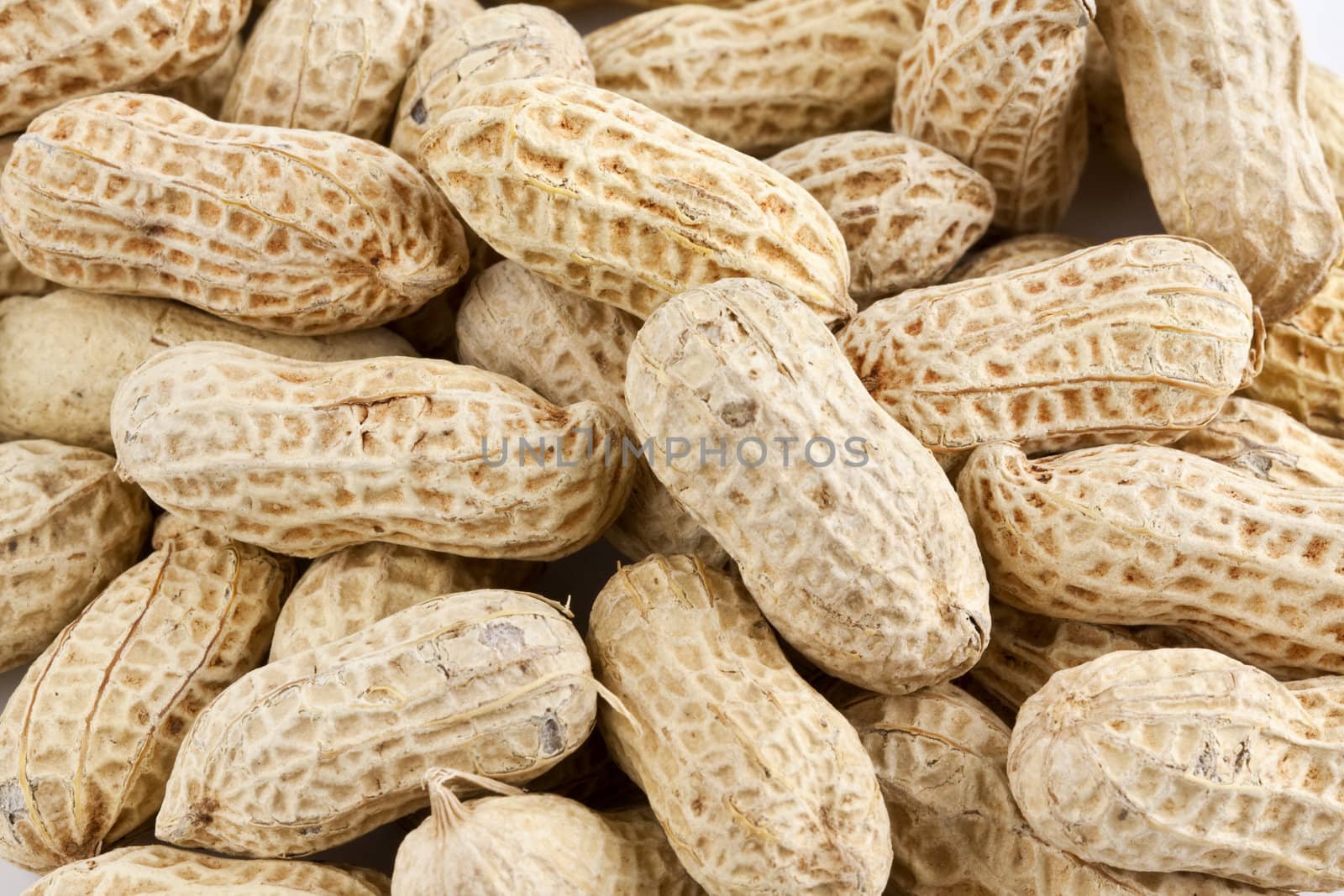 Background of roasted peanuts in shell