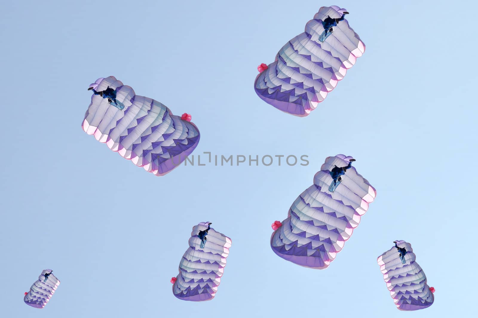 Many parachutes over a blue sky background