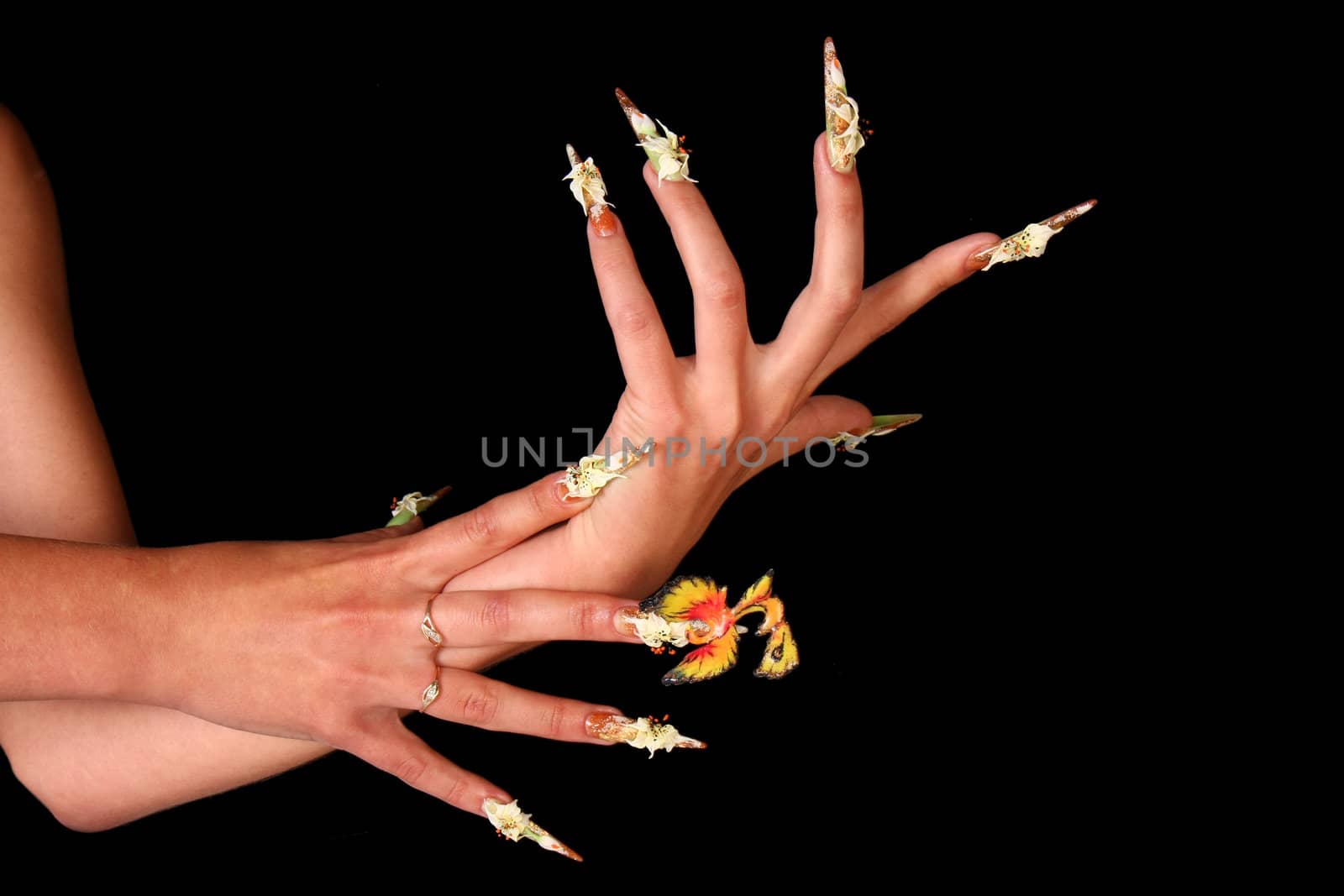 Human fingers with long fingernail and beautiful manicure isolated on black