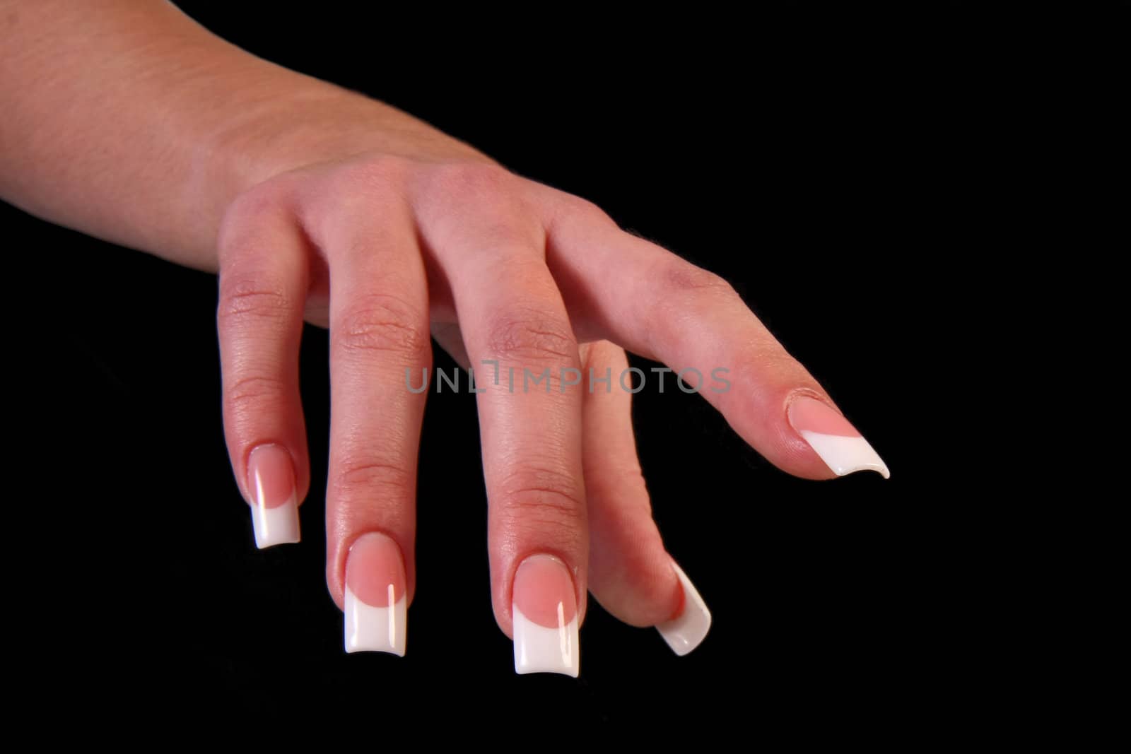 Human fingers with long fingernail and beautiful manicure isolated on black