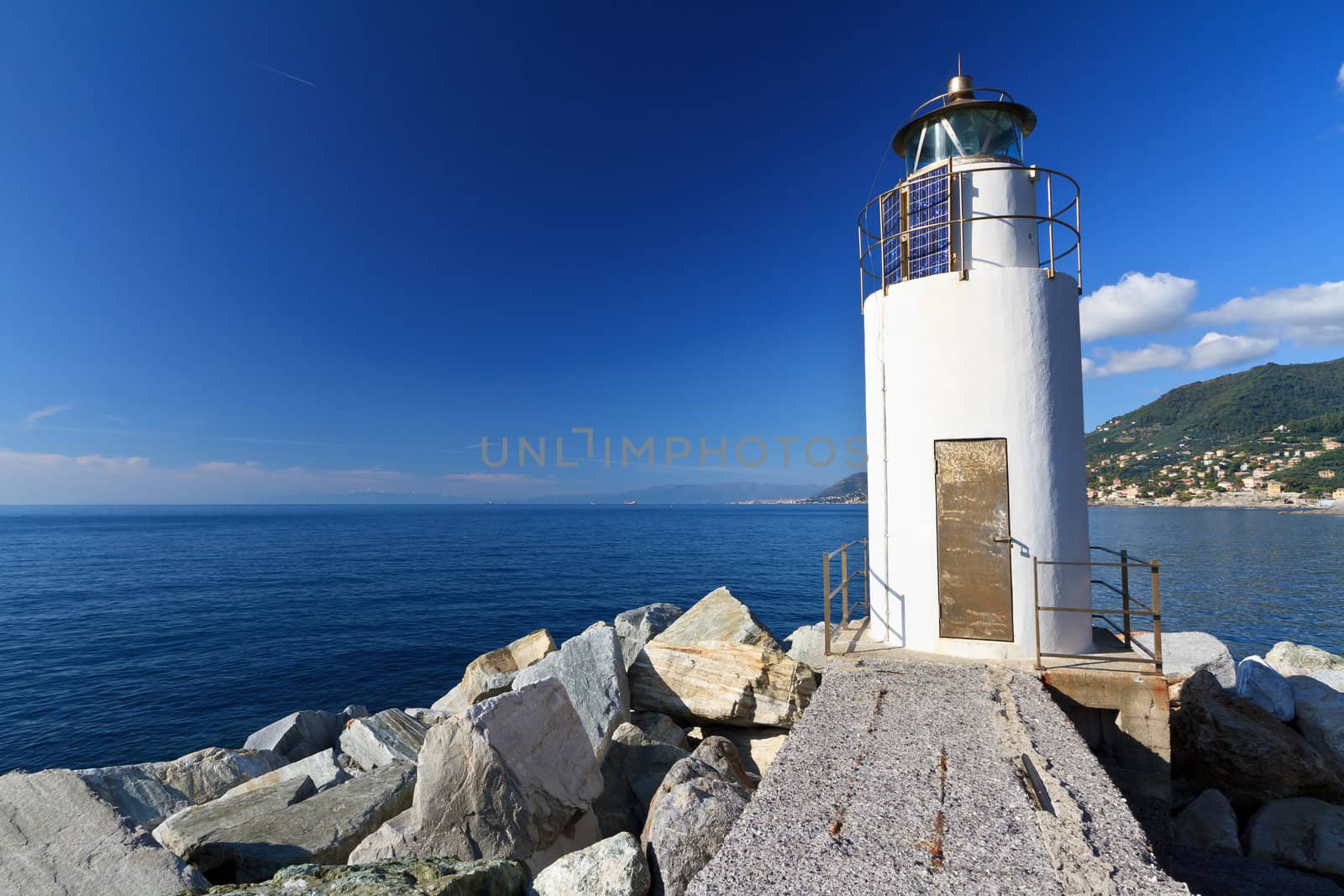 lighthouse over Mediterranean sea in Camogli, Italy