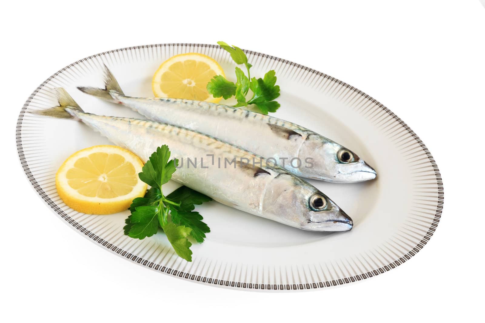 dish with two mackerels with lemon and pasley isolated on white background with clipping path