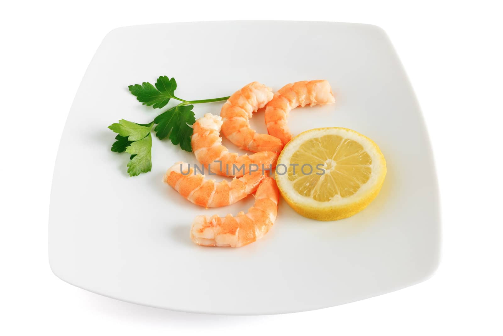 five shelled shrimps with lemon and parsley on a plate isolated on white background with clipping path