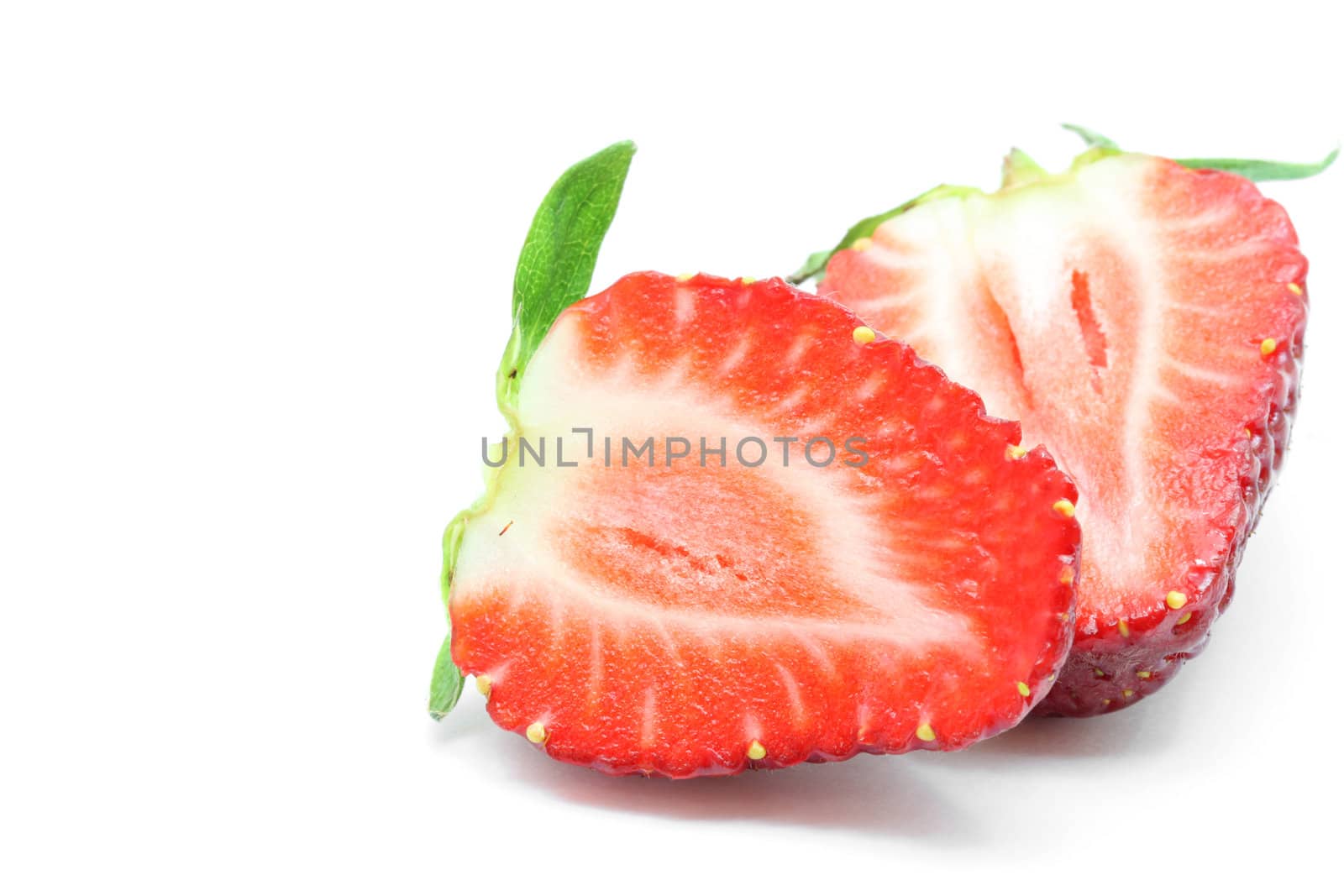macro shot of cut half Strawberry isolated over white background