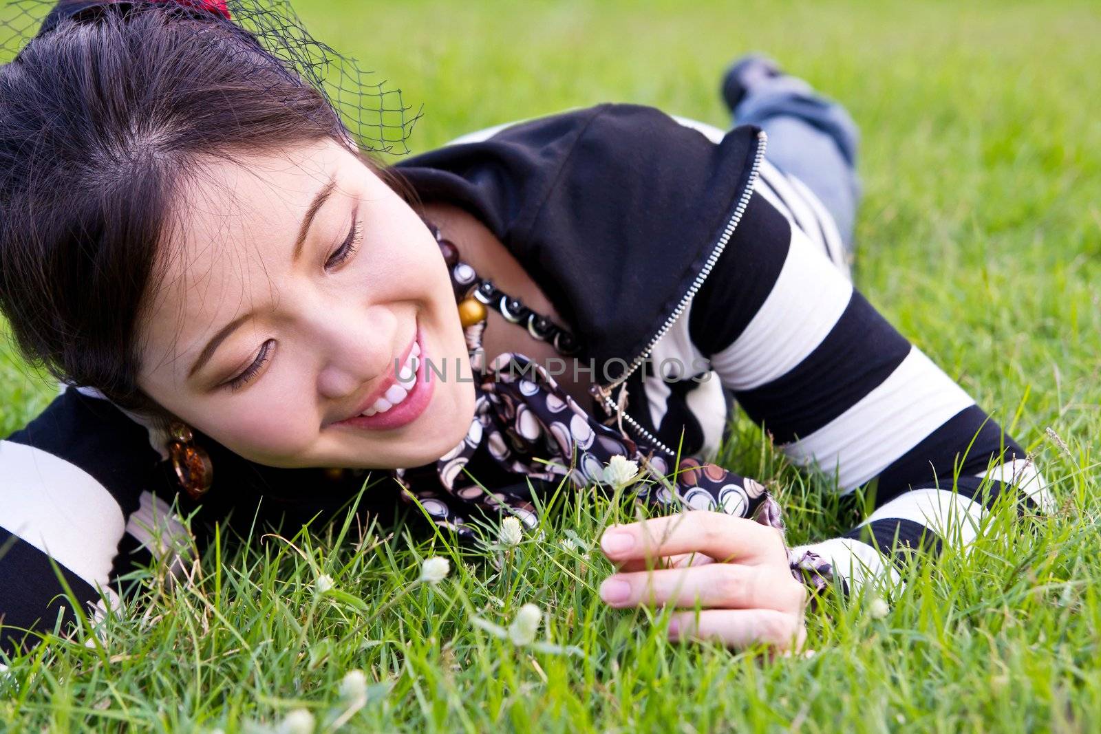 Asian woman relaxed on the grass by Myimagine