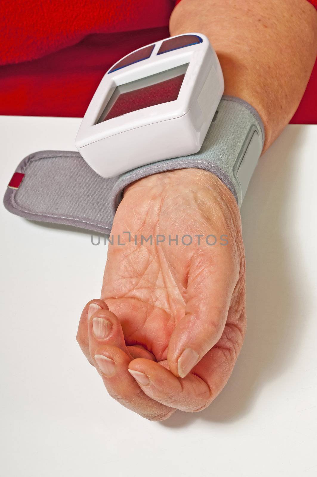 pensioner is measuring her blood pressure