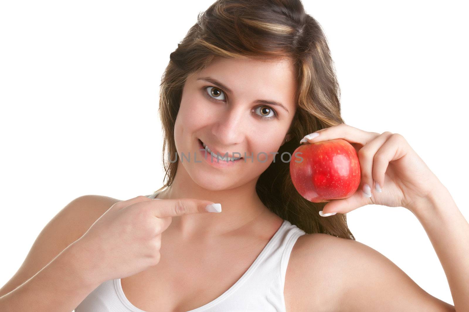 Woman smiling and pointing at a red apple she holds on her hand