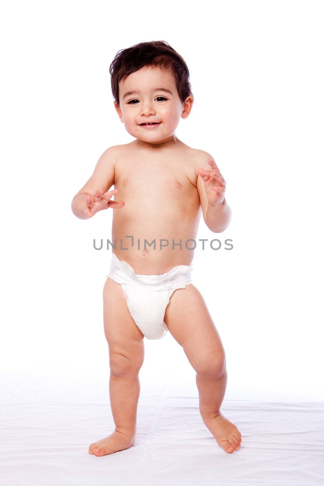 Cute happy baby toddler first steps learning how to walk in diaper, childhood concept.