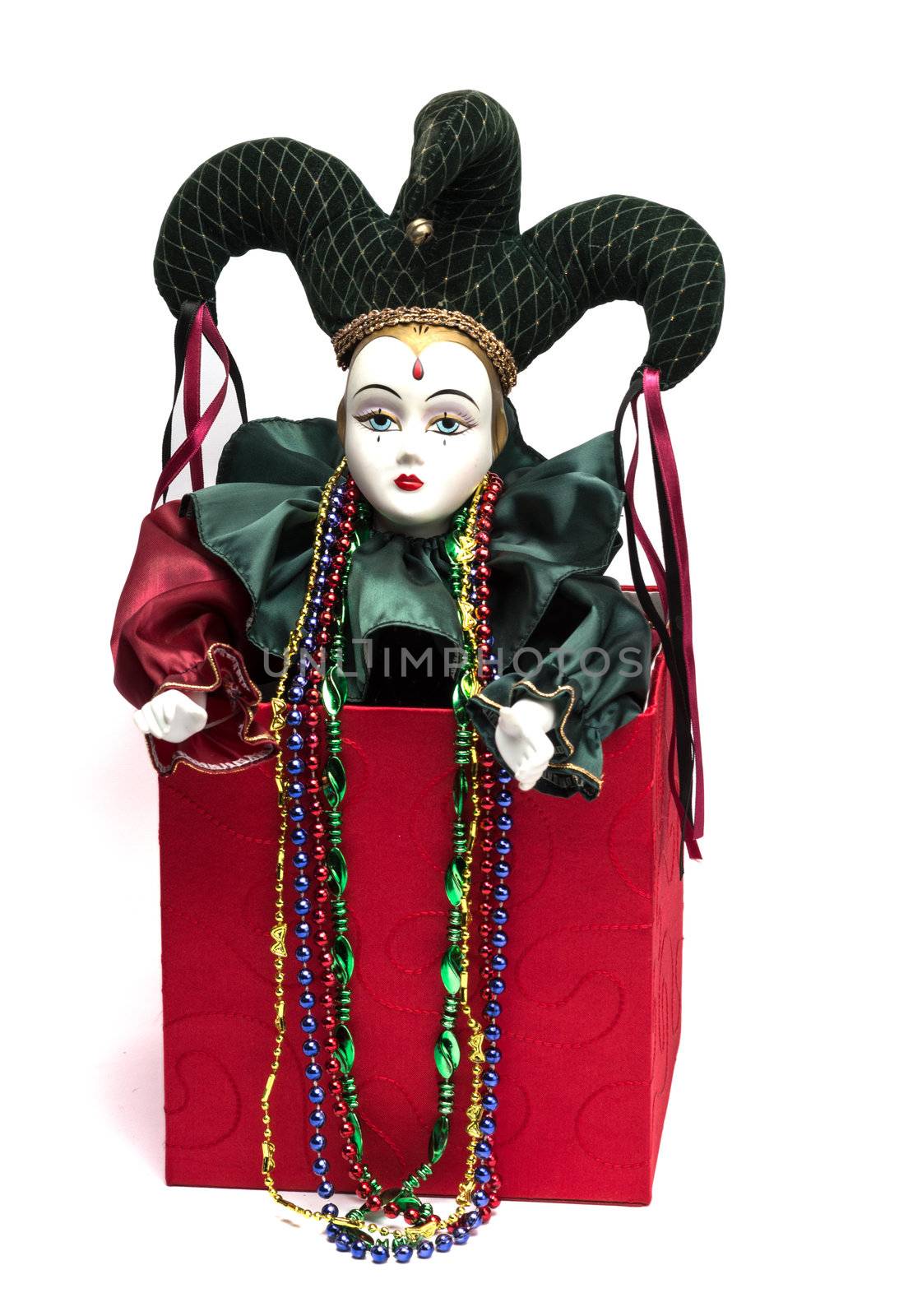 Mardi Gras Jack in the Box clown in red box with Mardi Gras beads. Isolated on white background.