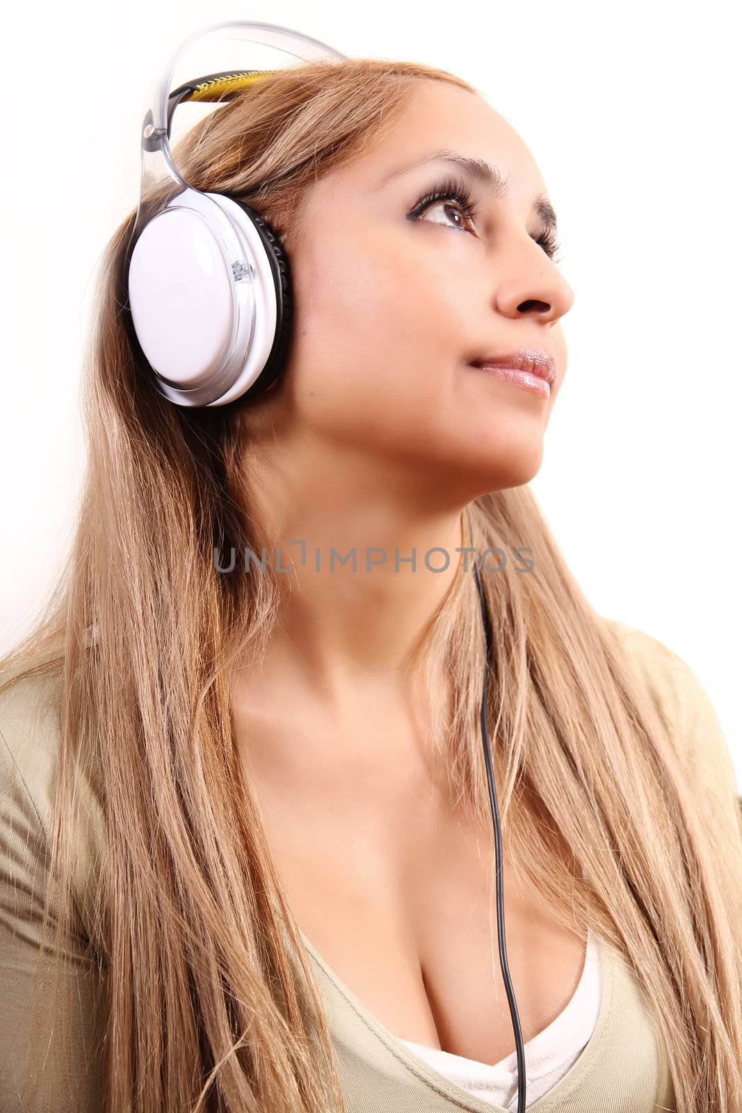 A girl listening to Music with Headphones. Isolated on white.