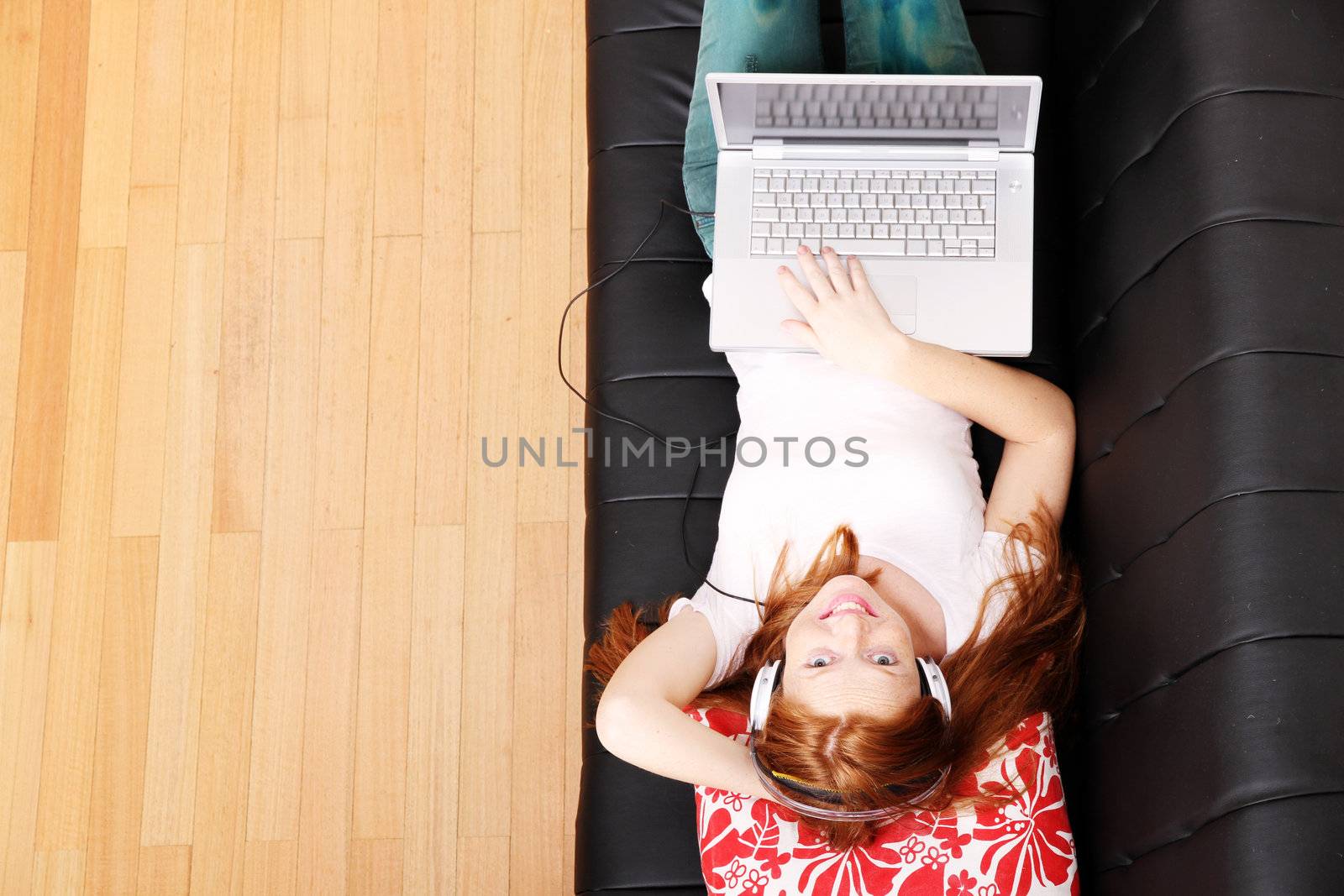 A young woman surfing on the Internet with a Laptop.  