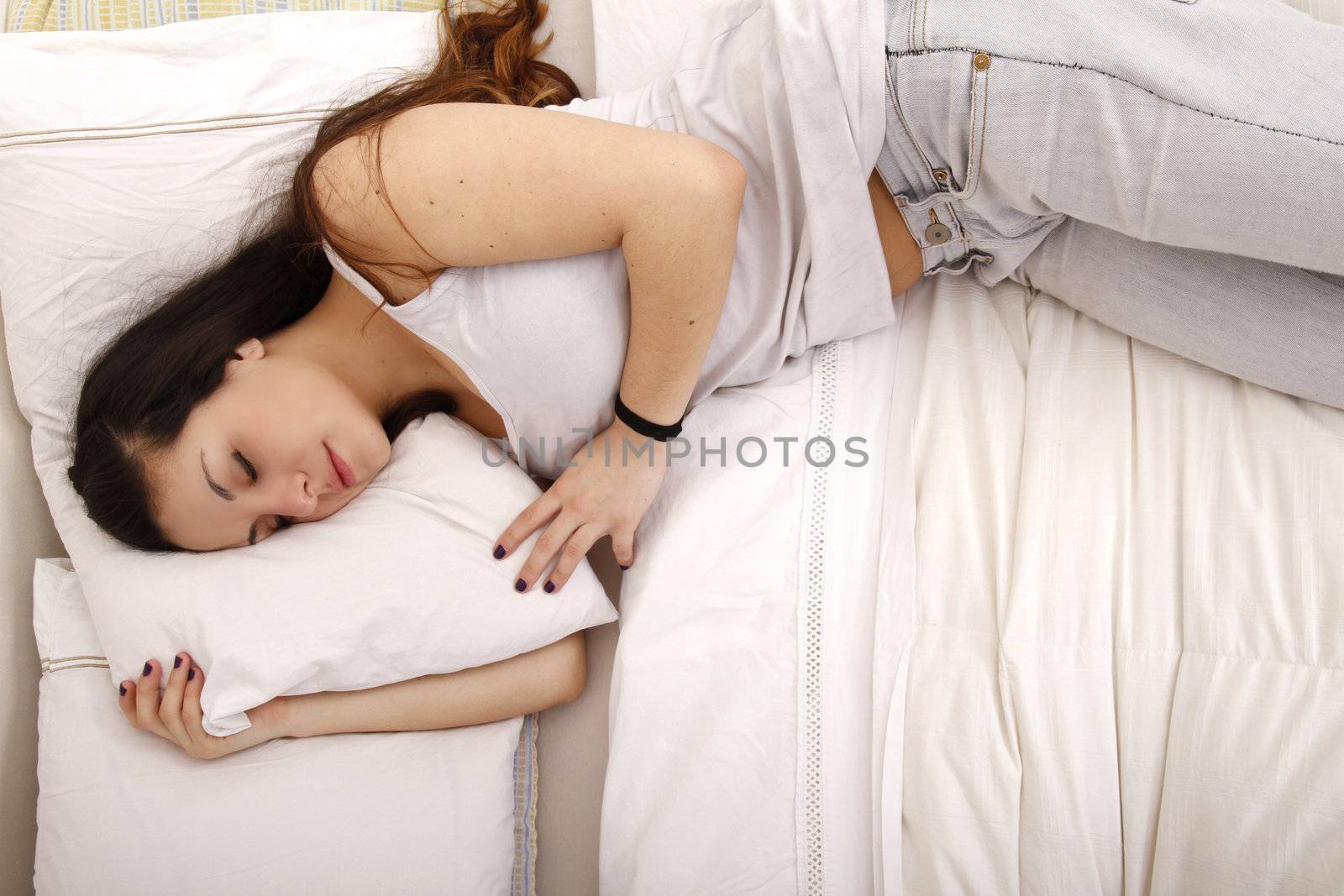 A young adult Woman sleeping on the Bed.