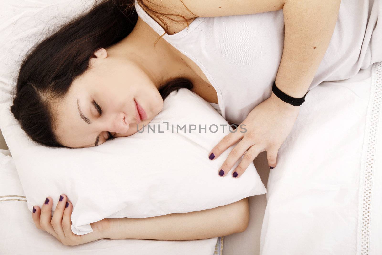 A young adult Woman sleeping on the Bed.