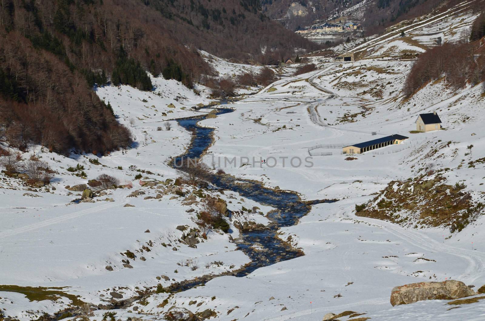 Winter Lanscape of Osseu valley (vallee d'Ossau) close to Col de Portalet,  , Atlantic Pyrenees, Aquitaine, Bearn, France. River Le gave d'Ossau, Farmers refuge and animal houses are in the down