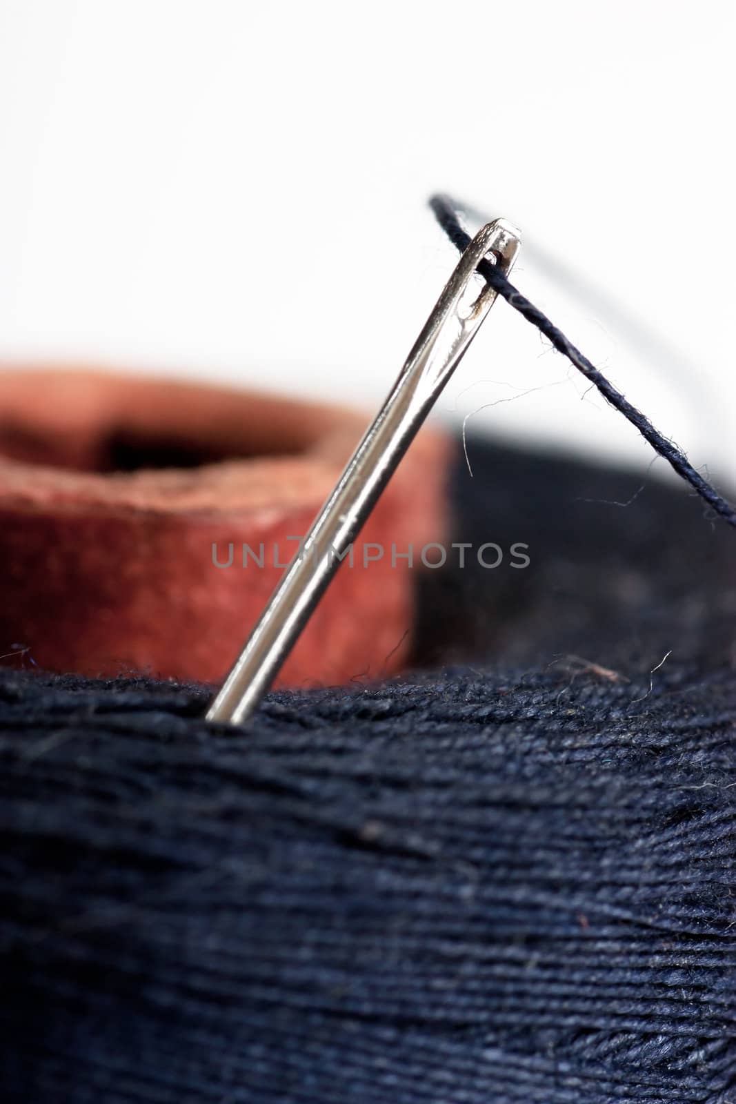 Macro view of needle and black thread