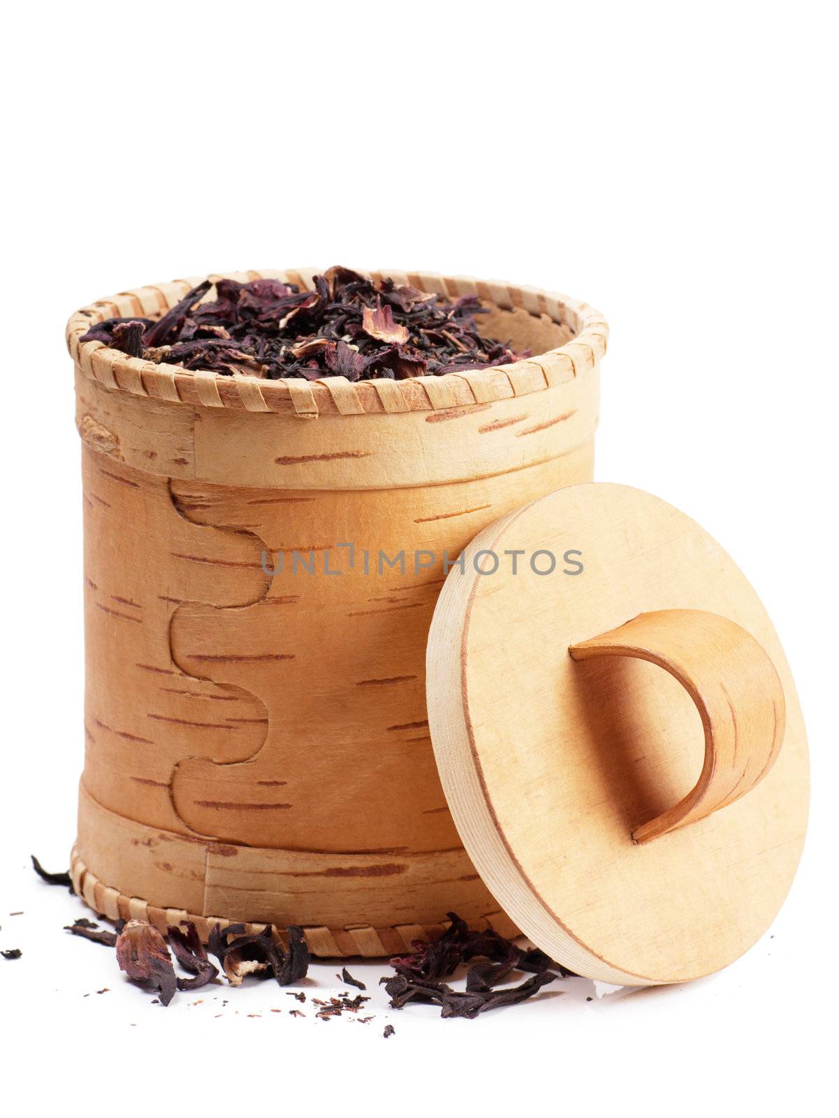 Birch bark box with red tea inside over white background