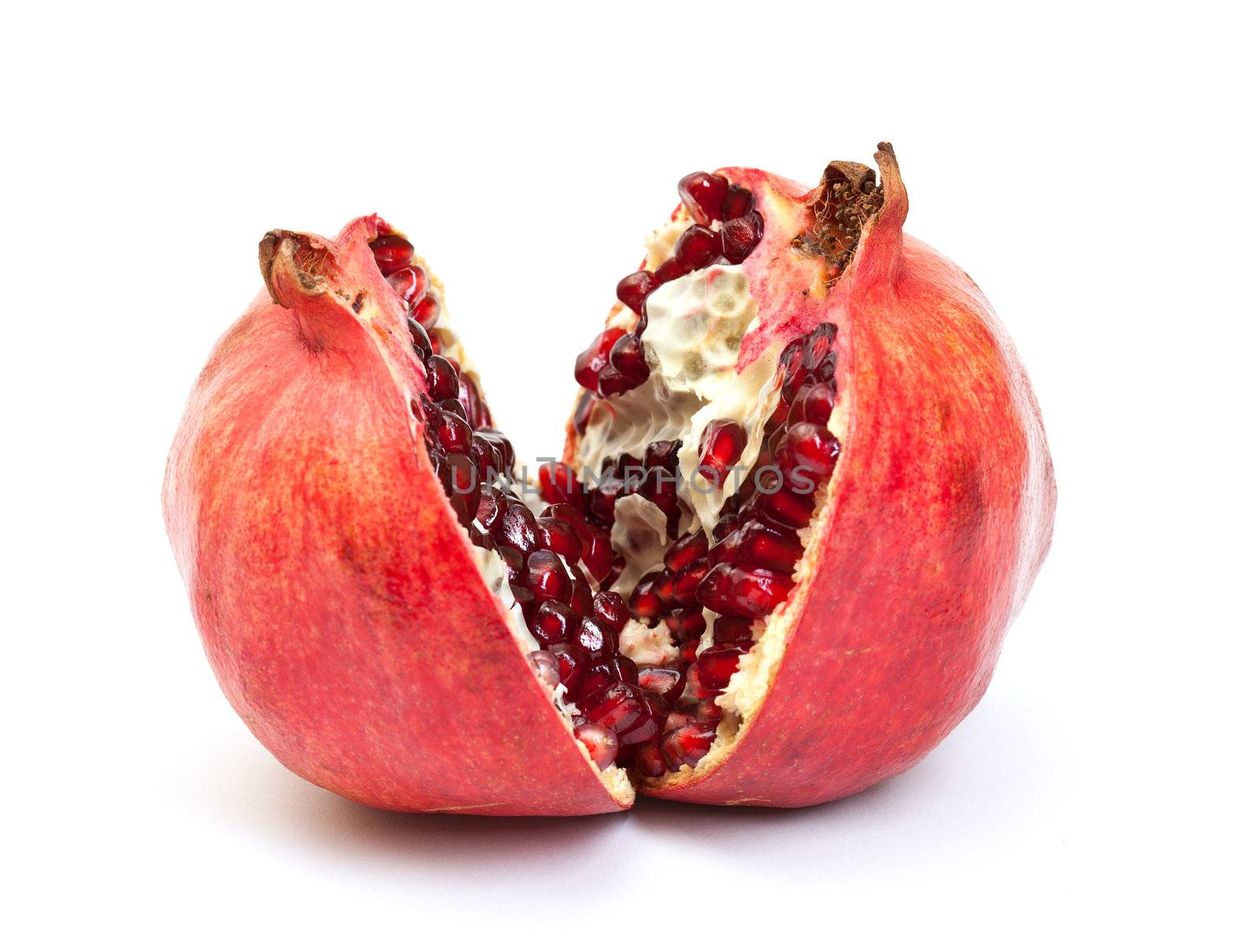 Broken pomegranate fruit on white background