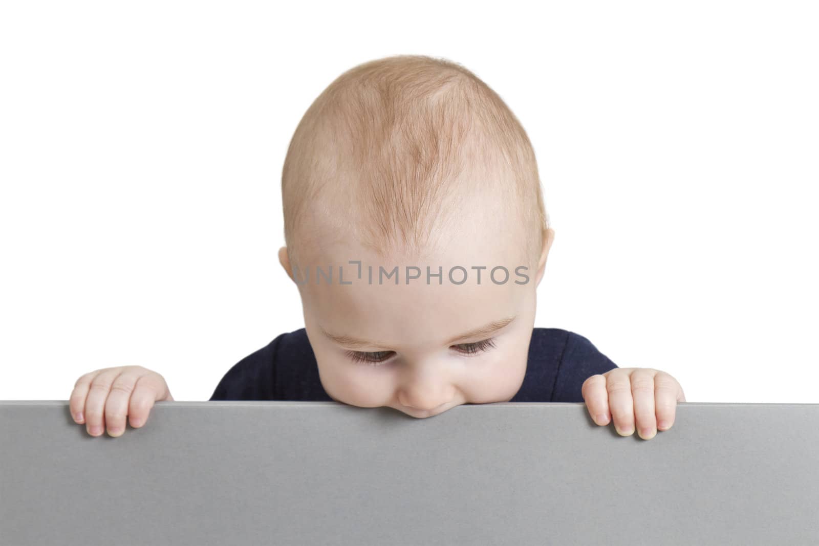 young baby holding blank grey cardboard. isolate on white background