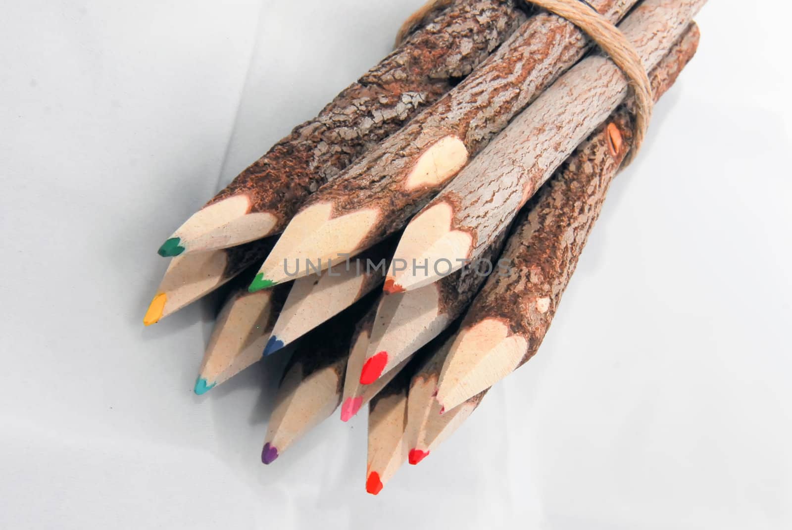 Sharpened multi colored pencils on white background