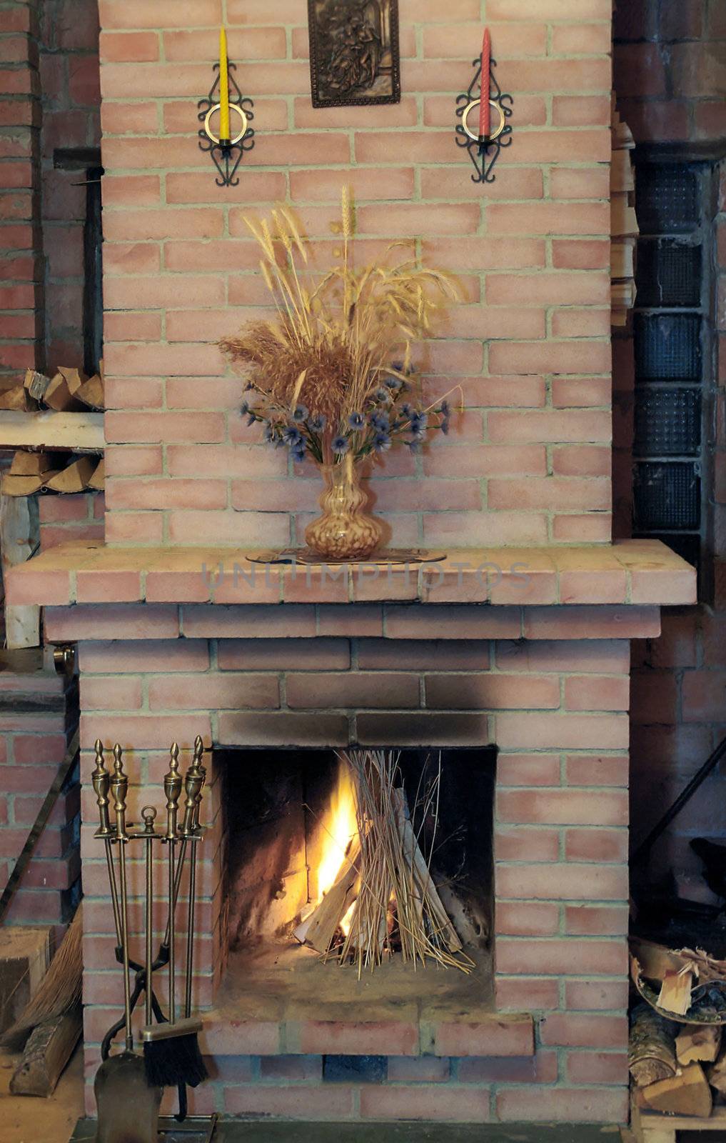 Fireplace with flame in village house