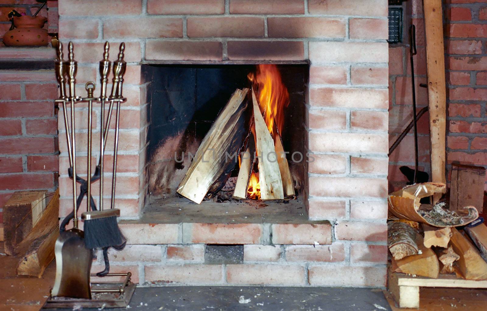 Fireplace with flame and fire irons