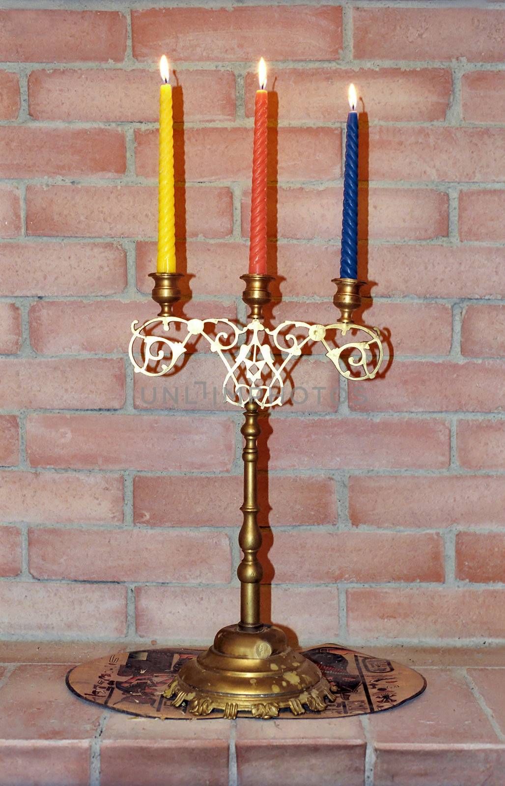 �andelabrum with three candles  on mantelshelf