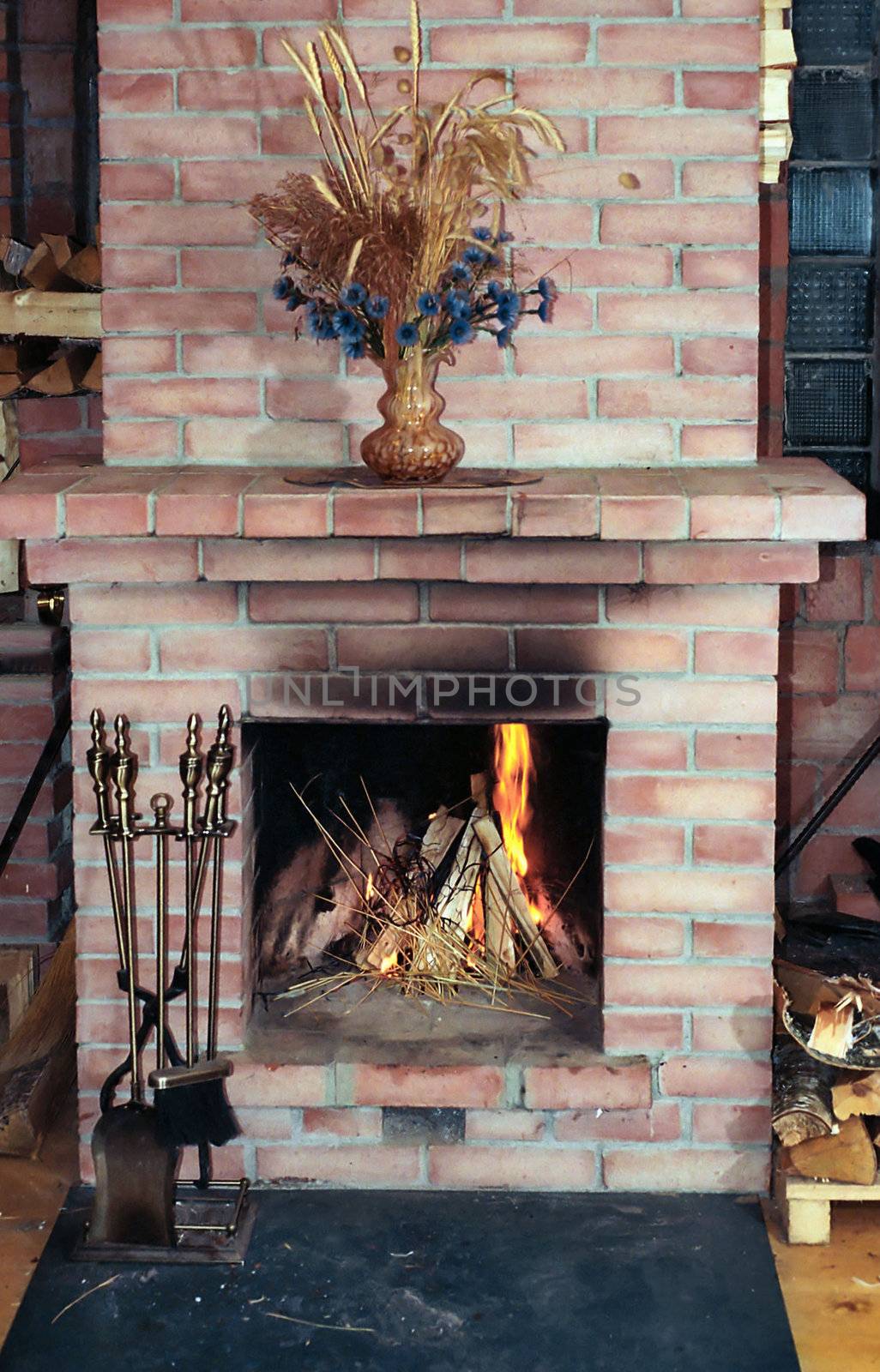 Village house fireplace with vase on  mantelshelf