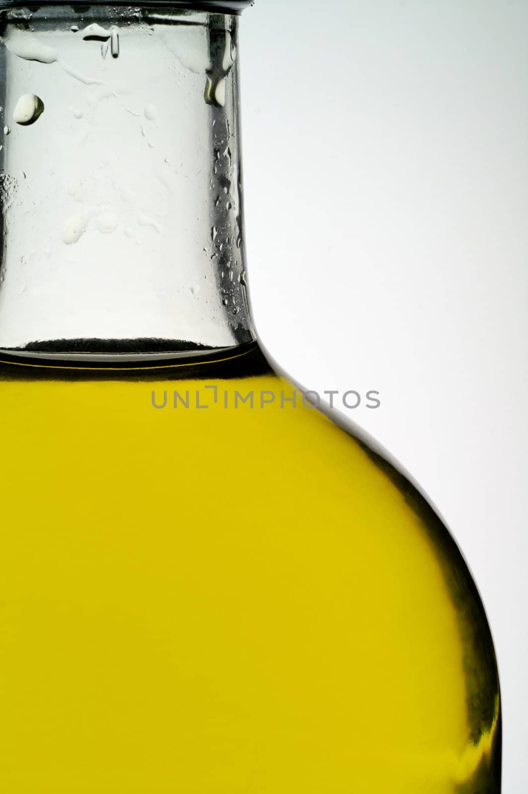 Olive oil bottle closeup by Laborer