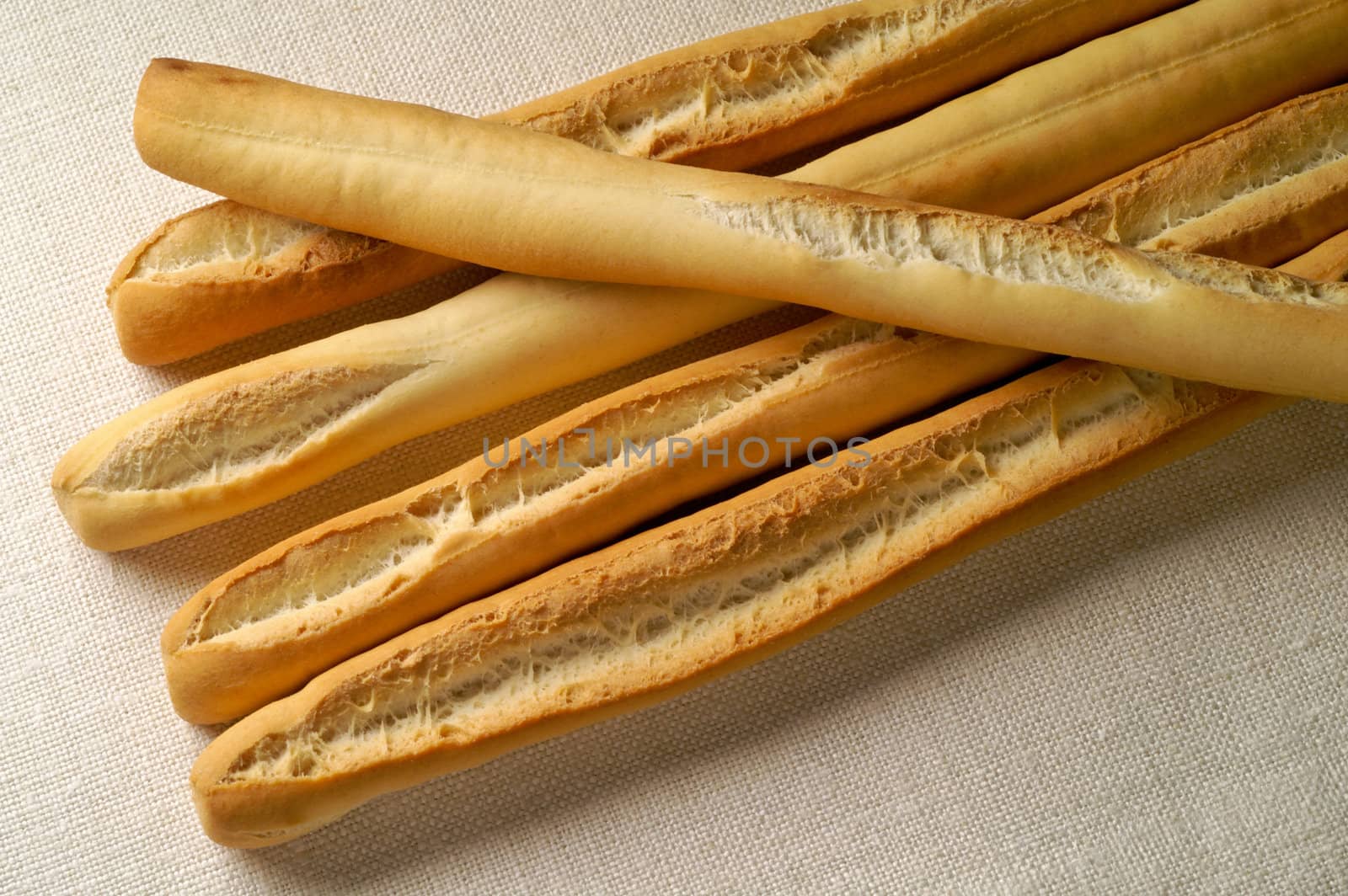 Grissini - Breadsticks on a linen napkin by Laborer