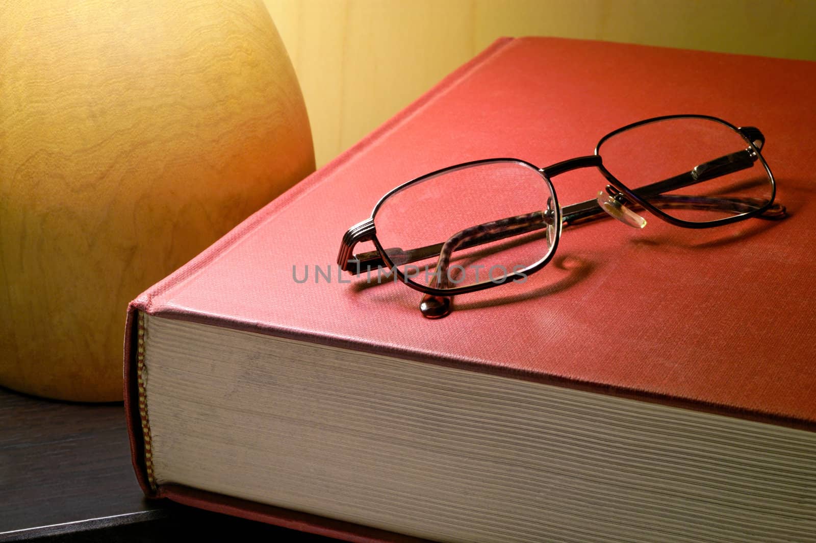 Book and glasses under lamp by Laborer