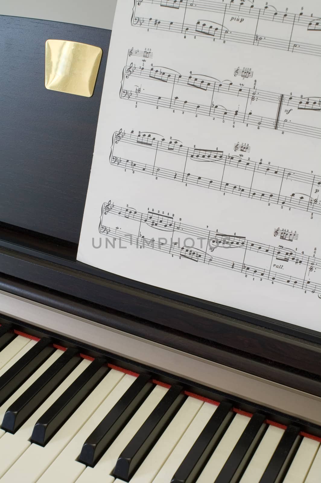 Piano keyboard with Bach score