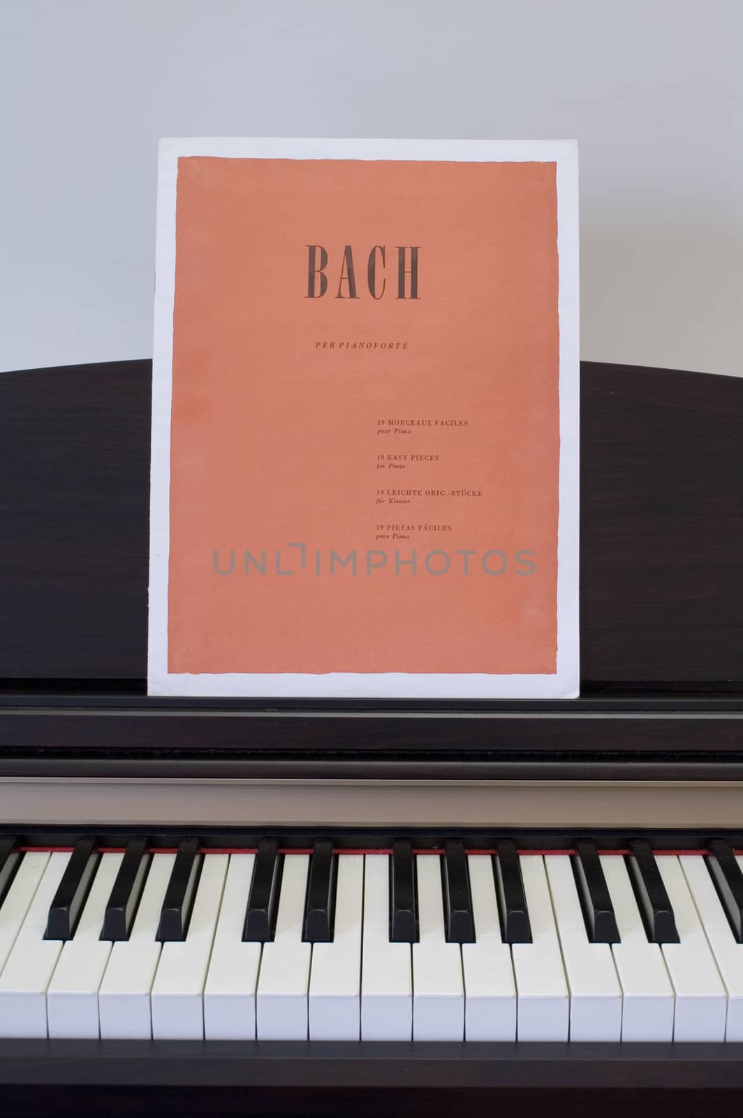 Piano keyboard with Bach score