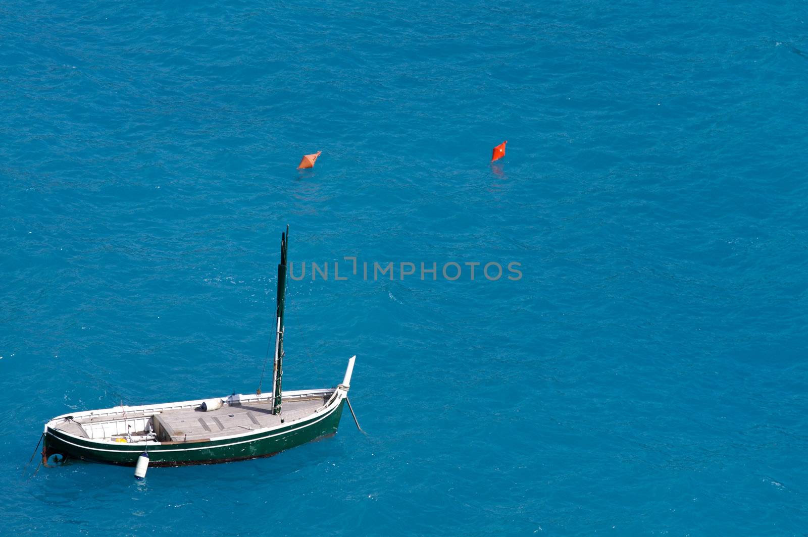 Boat floating on blue water. Space left intentionally blank for text